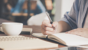 2019-09-27 20_40_15-Woman Writing on a Notebook Beside Teacup and Tablet Computer · Free Stock Photo