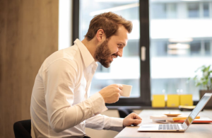 2019-12-20 08_37_29-Man Holding Teacup Infront of Laptop on Top of Table Inside the Room · Free Stoc